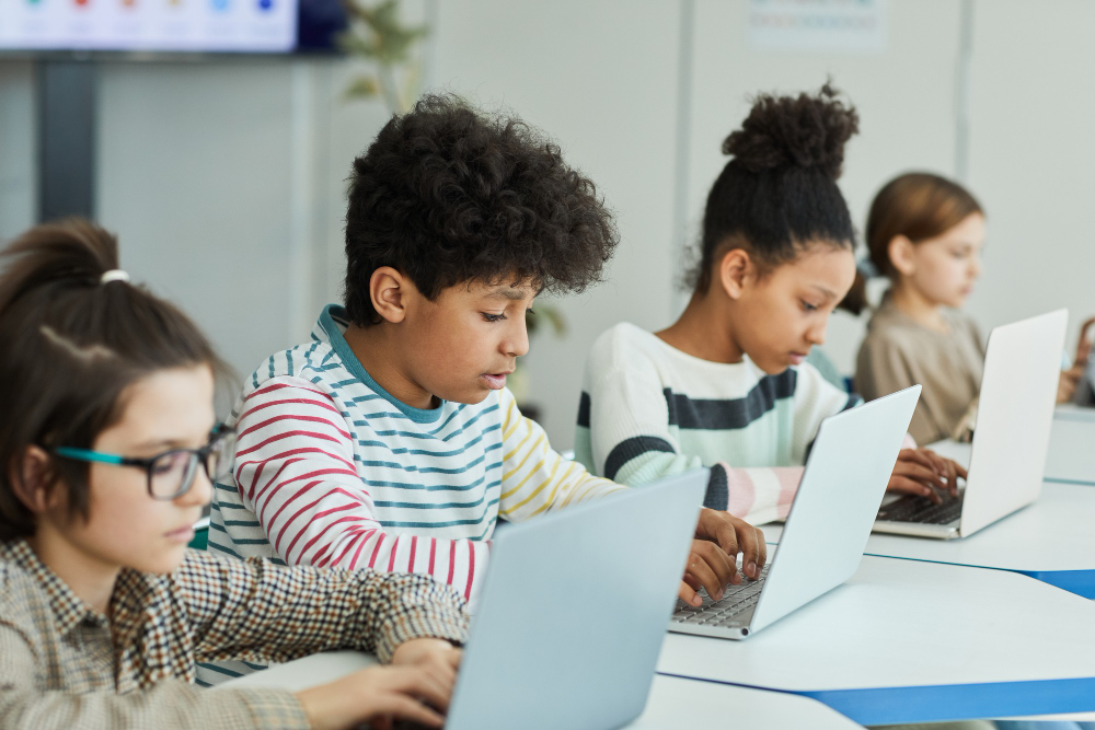 Diverse children doing homework on a laptop computer